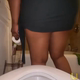 A black woman in a green skirt pulls it up and bends over a toilet, spreading her big ass. Her asshole opens and a long, thick turd slides out and hangs from her ass. No product reveal. Vertical format video. Over half a minute.
